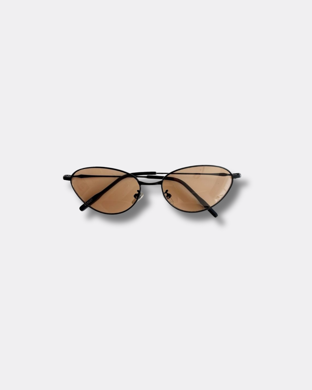 Sunglasses with brown lenses and black frames on a light gray background