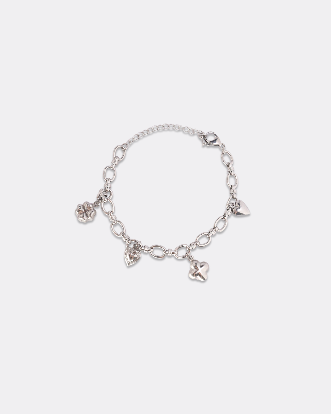 Silver charm link bracelet with heart and clover accents