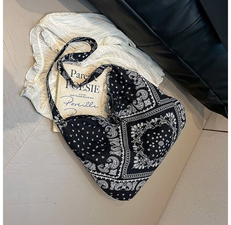 Black bandana with white patterns on a white surface