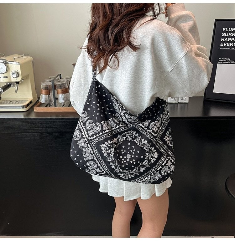Person wearing a black and white patterned bag in an indoor setting